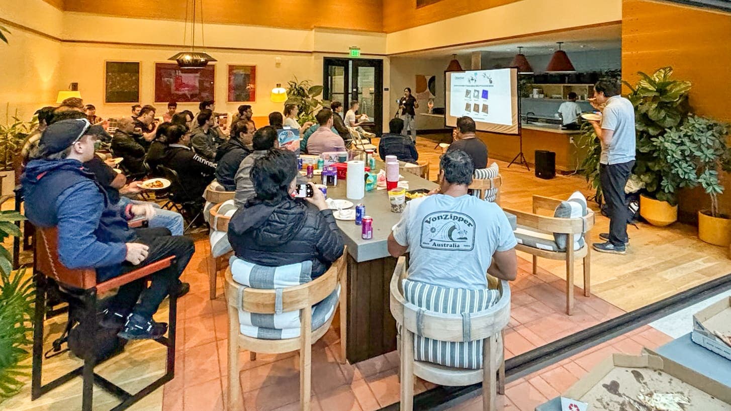 People talking around tables at an evening meetup